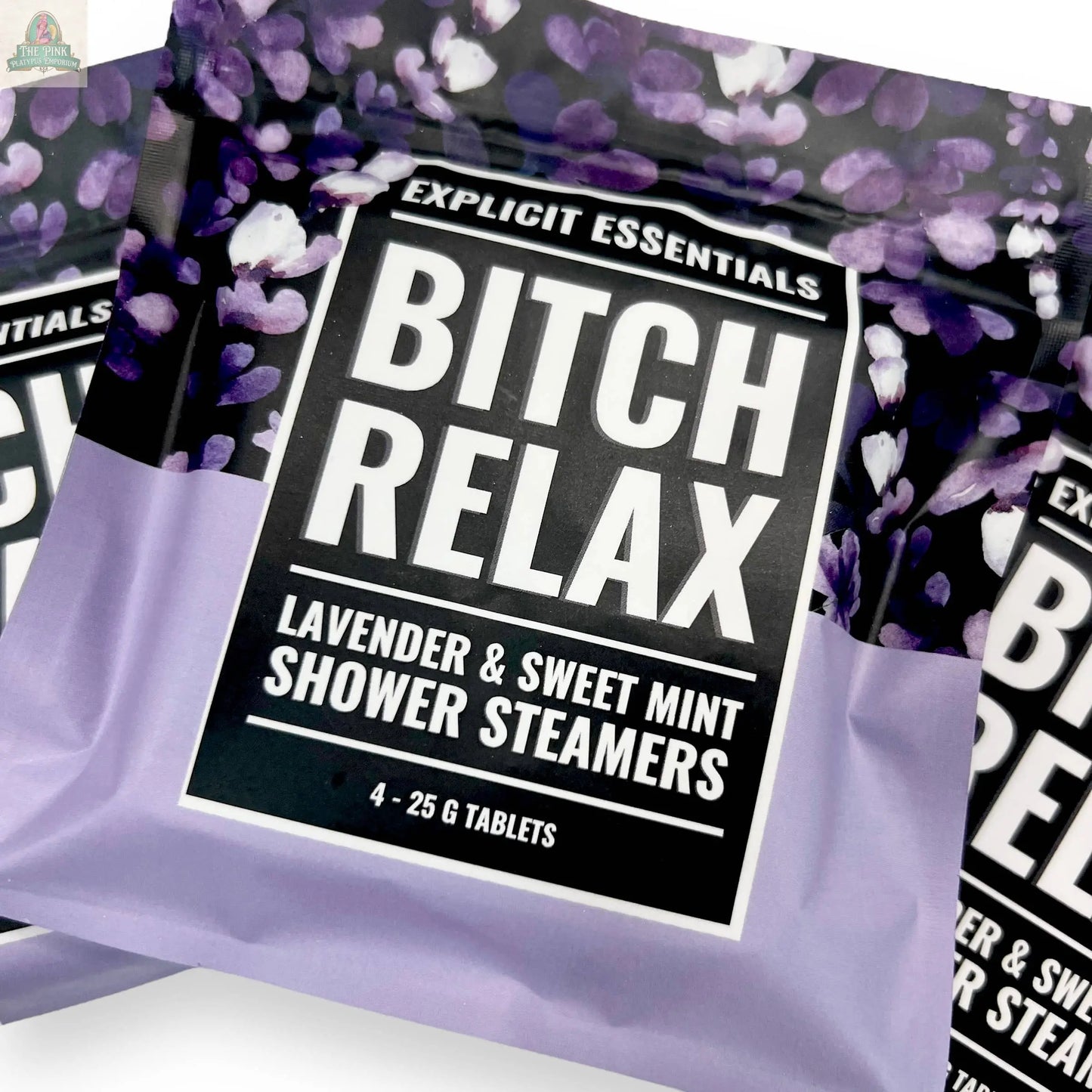 Bitch Relax Shower Steamers by Explicit Essentials feature a black and lavender design with floral accents and bold white text—ideal for self-care gifts or relaxing at home.