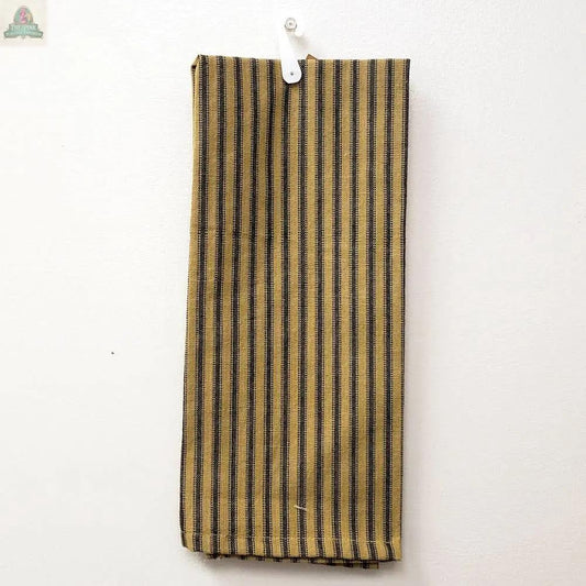The Black Ticking Kitchen Towel, measuring 15 x 25 inches with vertical yellow and black stripes, hangs from a white hook on a plain white wall.