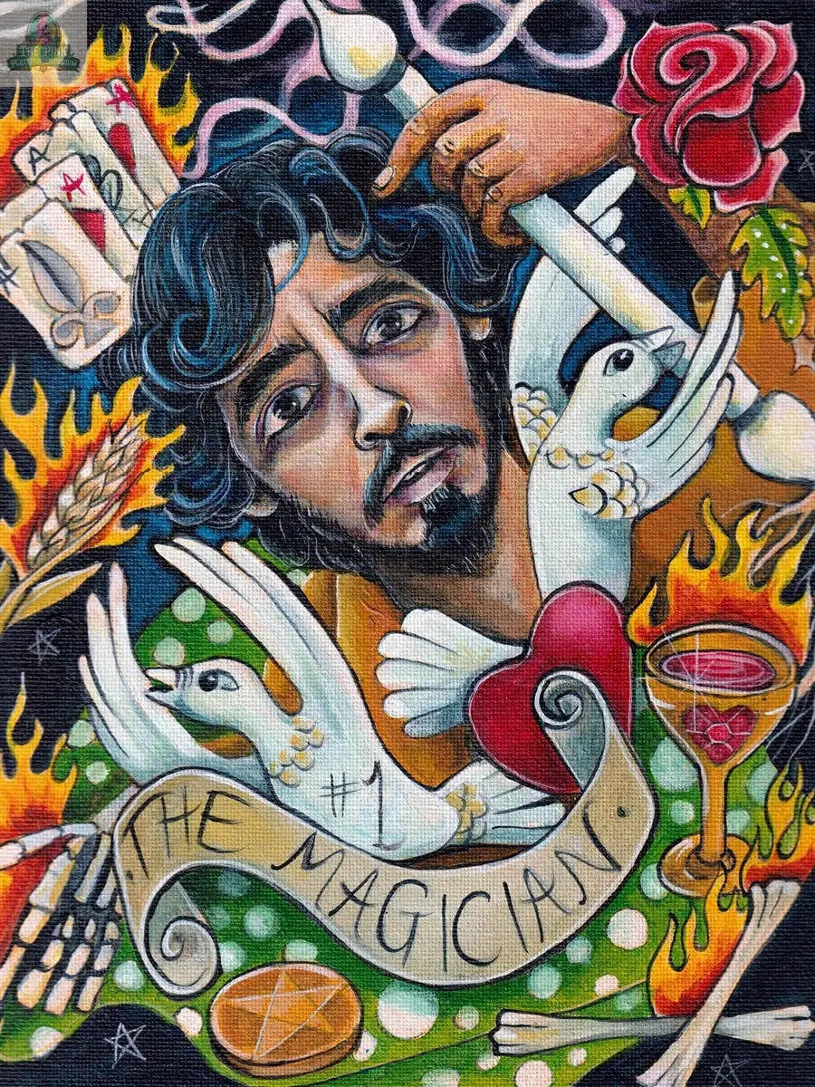 A vibrant, mystical artwork from the Bonefire Tarot, 2nd Edition by REDFeather shows a man with dark curly hair pointing at his head, surrounded by doves, flames, a rose, candles, Tarot cards, a heart, and a “#1 The Magician” banner.