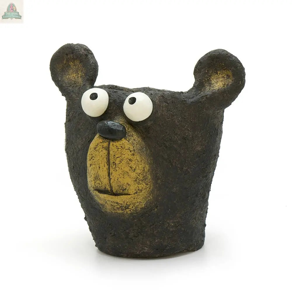The Bruno the Black Bear Head Blobhouse Planter by Blob House Planters features a textured dark brown finish, round ears, big white eyes with black pupils, and a yellow snout—ideal for showing off your favorite succulent.