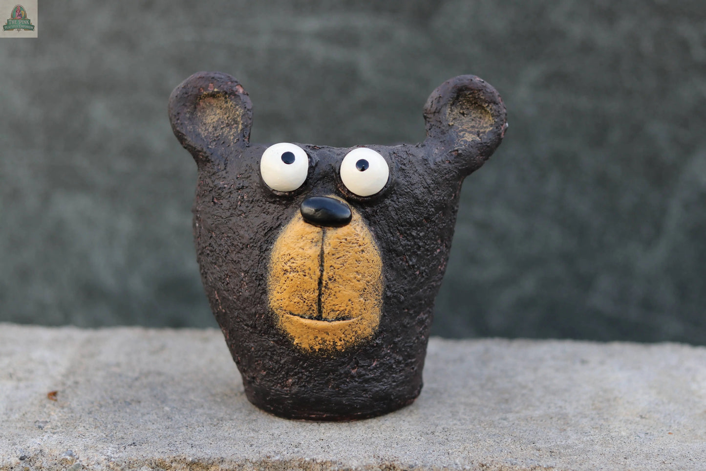 Bruno the Black Bear Head Blobhouse Planter by Blob House Planters is a small, handmade clay sculpture with wide white eyes and a yellowish snout, perfect for adding whimsy to your space.
