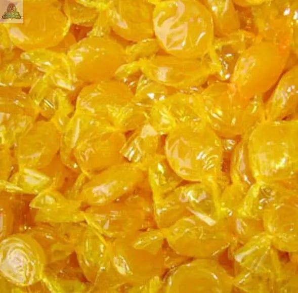A close-up of many round, shiny Butter Rum Atomizer Oils, each individually wrapped in clear plastic with twisted ends, resembling bright, colorful potpourri.