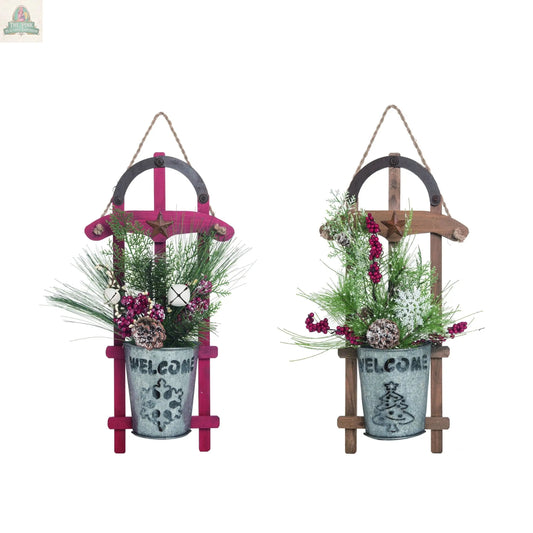 This 20" Wood Sled Ornament features a small potted plant with pine branches, berries, and cones, plus a "WELCOME" pot and accents like horseshoes, stars, and twine—perfect Christmas decor for hanging on your wall.
