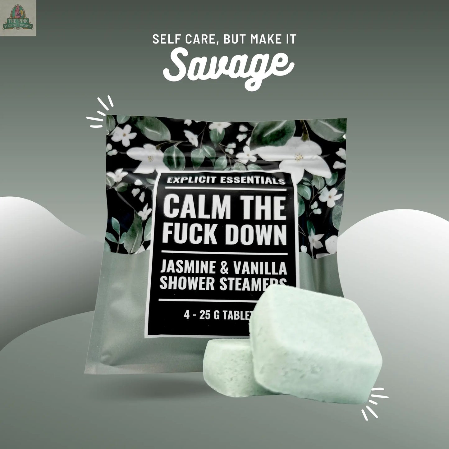 A package labeled Calm TF Down Shower Steamers by Explicit Essentials sits with two light green shower steamers in front. White flowers are in the background, and the text above reads: Self care, but make it savage.