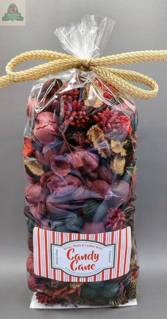 Candy Cane Handcrafted Potpourri- 5 cups: Festive red, purple, and brown potpourri in a clear bag tied with a gold bow, featuring a candy cane label—perfect as a scented bowl filler for home fragrance.
