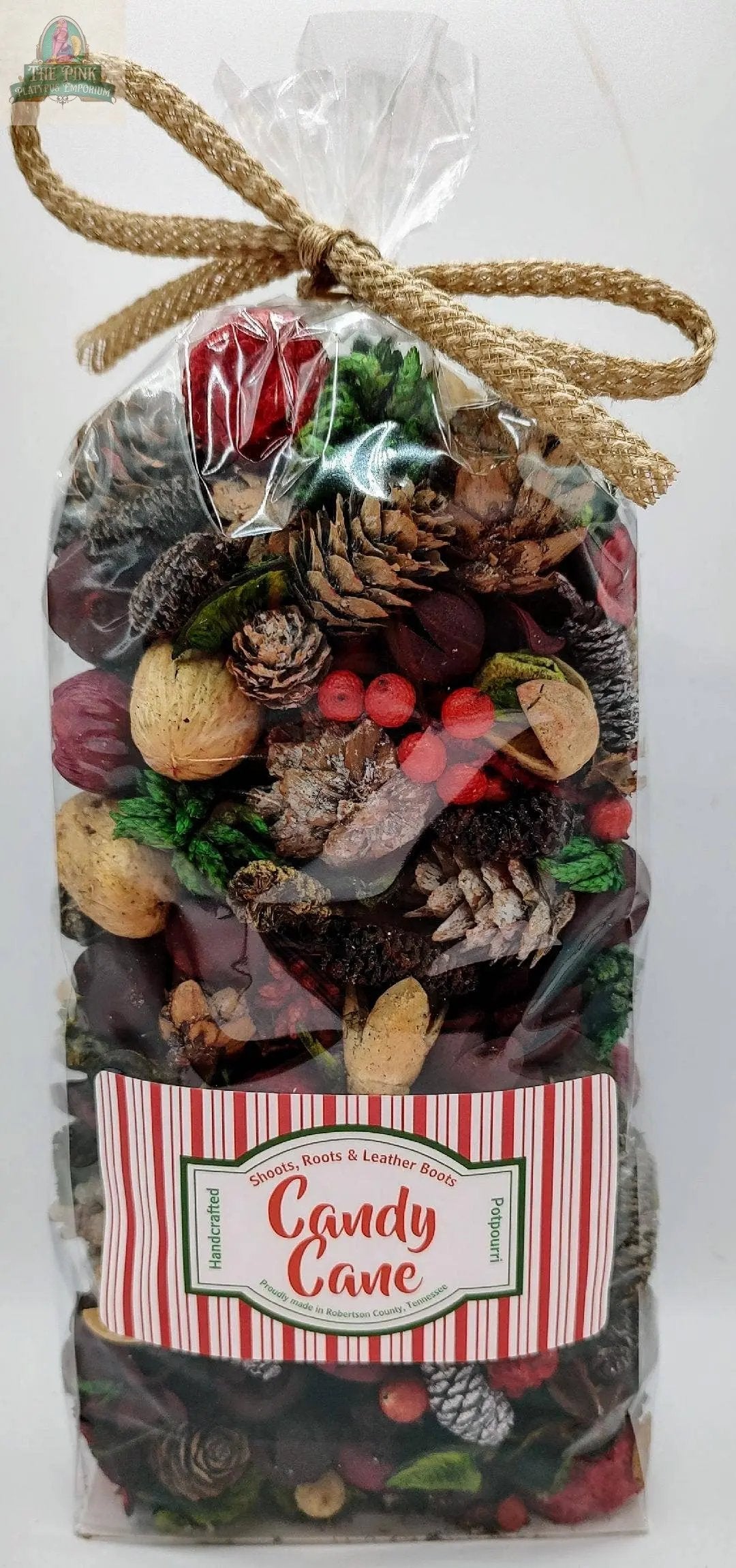 Candy Cane Handcrafted Potpourri (5 cups) comes in a clear bag tied with a gold cord and filled with festive pinecones, red berries, nuts, and botanicals. Its red-and-white striped holiday label makes it ideal for home fragrance or bowl decor.