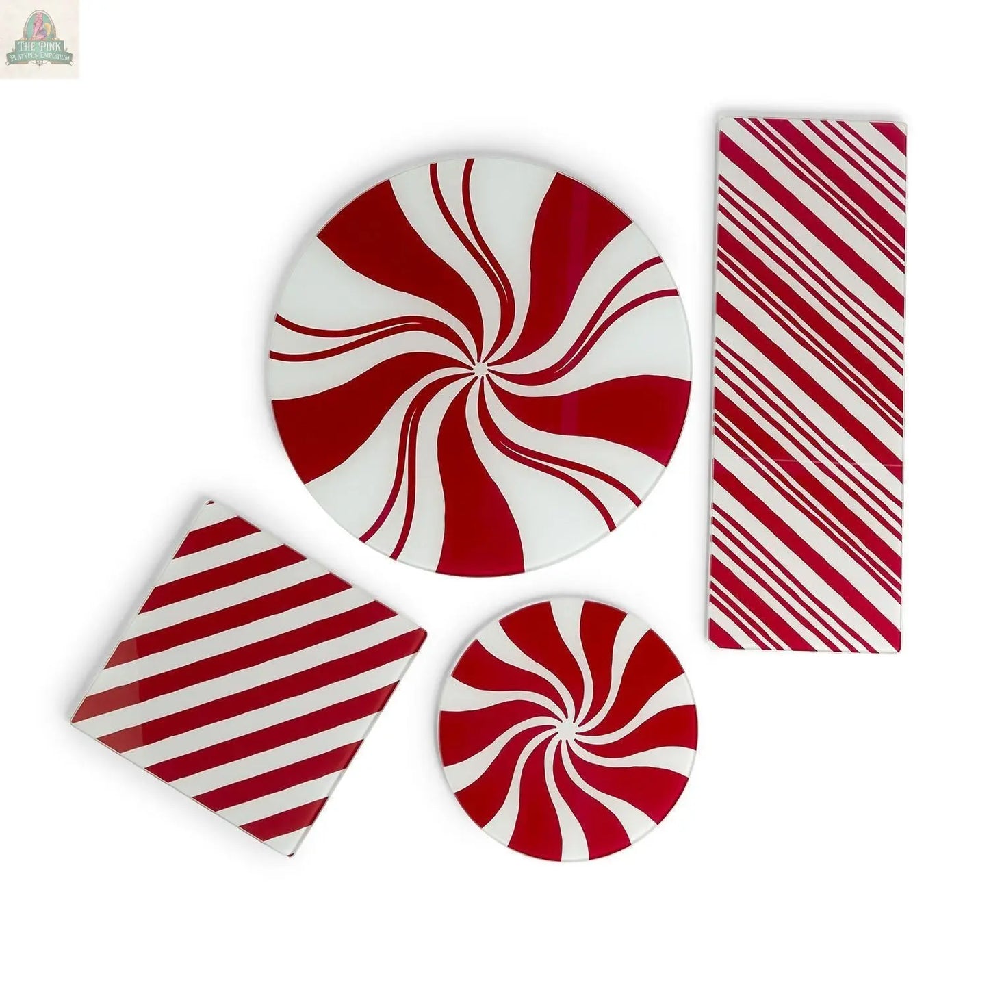 The Candy Cane Serving set includes four glass platters—two round with swirling red and white stripes, two rectangular with diagonal stripes—adding festive charm to your holiday kitchen when arranged on a crisp white background.