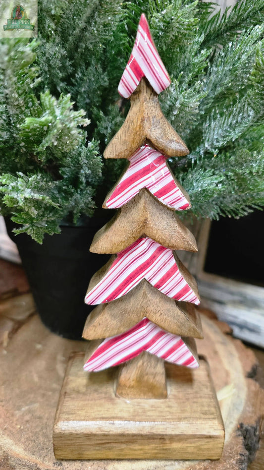 The Candy Striped Downswept 8x3.5x3in features alternating layers of natural wood and red-and-white stripes, creating a charming decorative Christmas tree for your holiday tabletop décor.