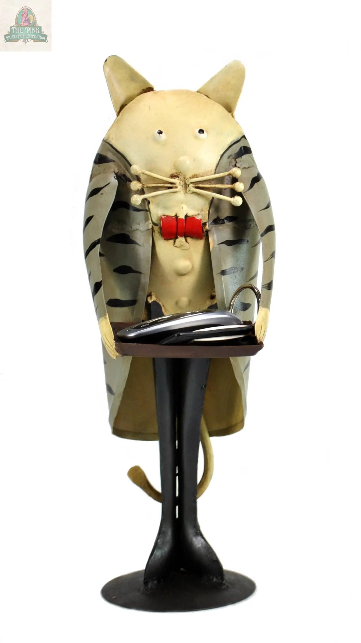 The Cat Butler with tray figurine is a whimsical 13" vintage décor piece made of iron, featuring exaggerated facial features and a striped coat, and holds a decorative cat tray with a silver fish.