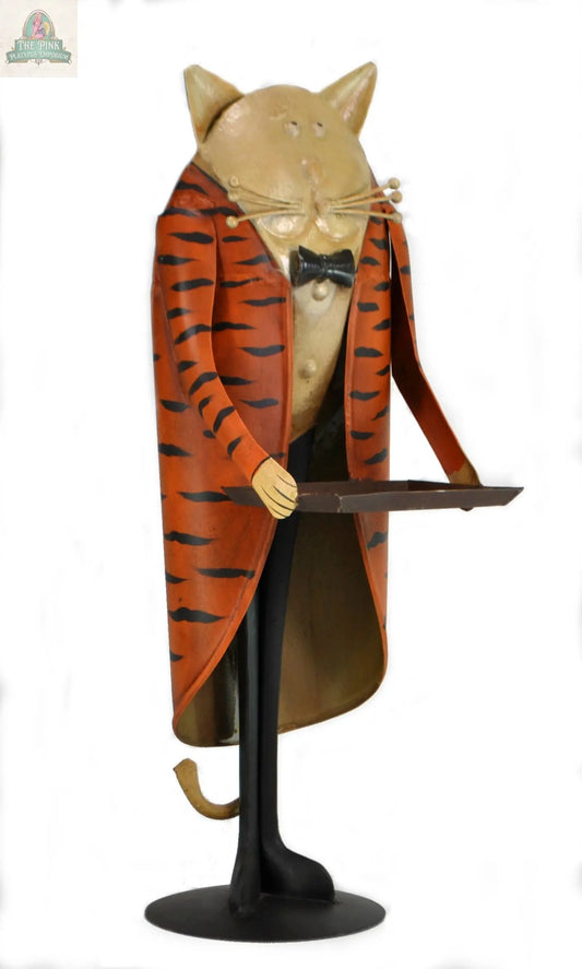 Add vintage charm to your space with this 22" Cat Butler with tray figurine, featuring a handcrafted iron cat in an orange and black striped jacket, bow tie, and black pants, standing proudly on a base holding a tray.