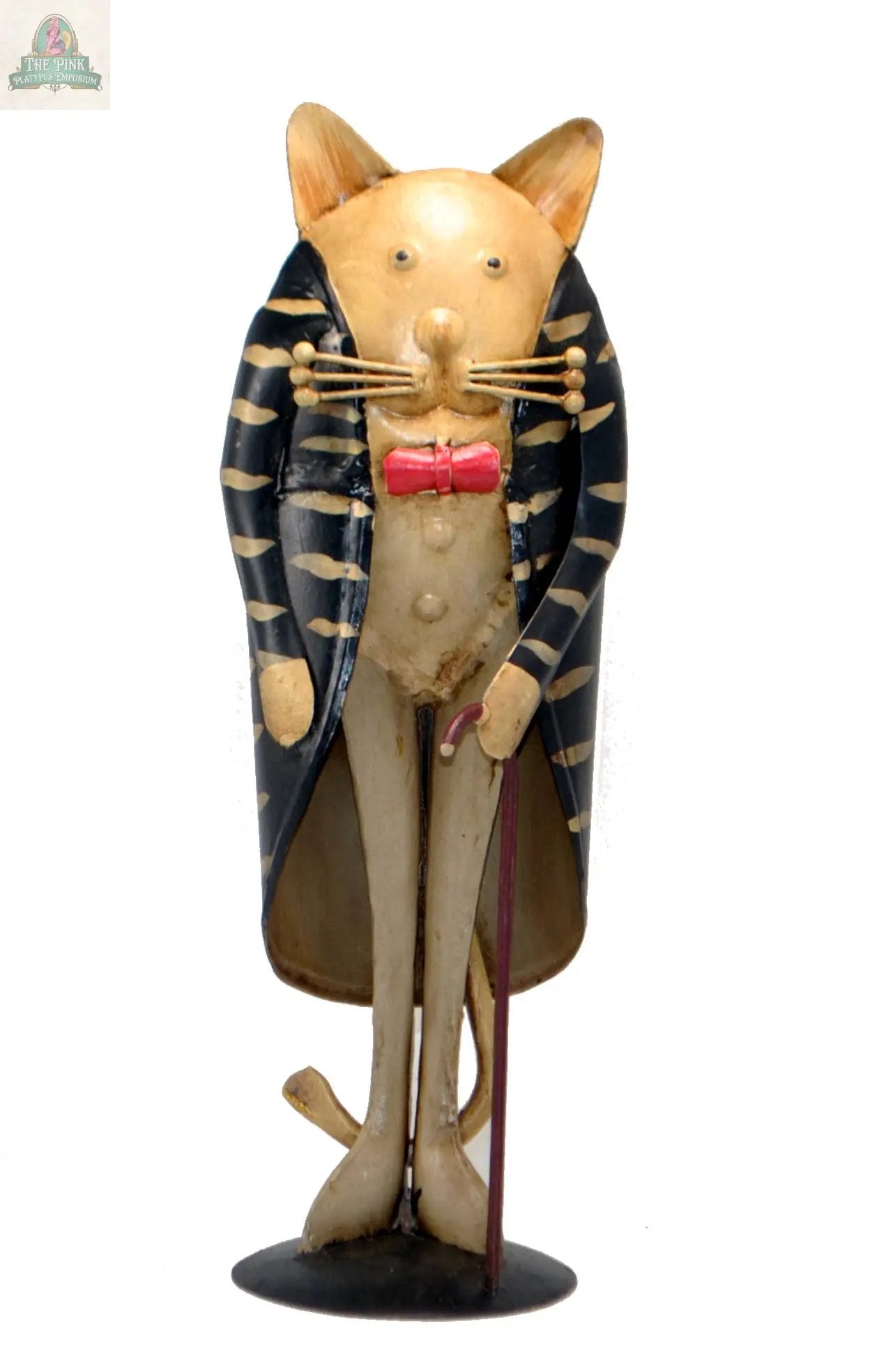 The Cat Figurine with walking stick is a hand-painted, small décor piece with a vintage look. It stands upright with exaggerated features, wearing a black and gold cape, red bow tie, and holding a cane for whimsical charm.