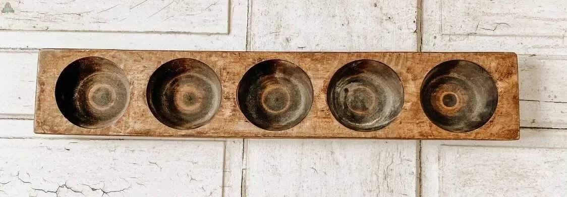 The Cheese Mold - 5 Hole, Farmhouse Decor #B - 6.5 is a rectangular wooden tray with five round depressions, made from real wood and displayed on a rustic white surface—ideal for unique home décor or showcasing cheesemolds.