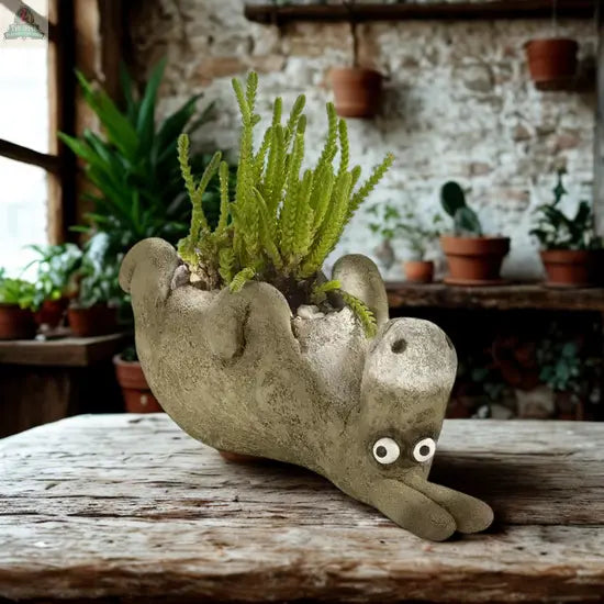 Add a whimsical touch to any space with Chester, the Donkey Blobhouse Planter Laying from Pink Platypus Emporium—a charming handcrafted poly-resin piece complete with a lush plant for delightful garden decor.