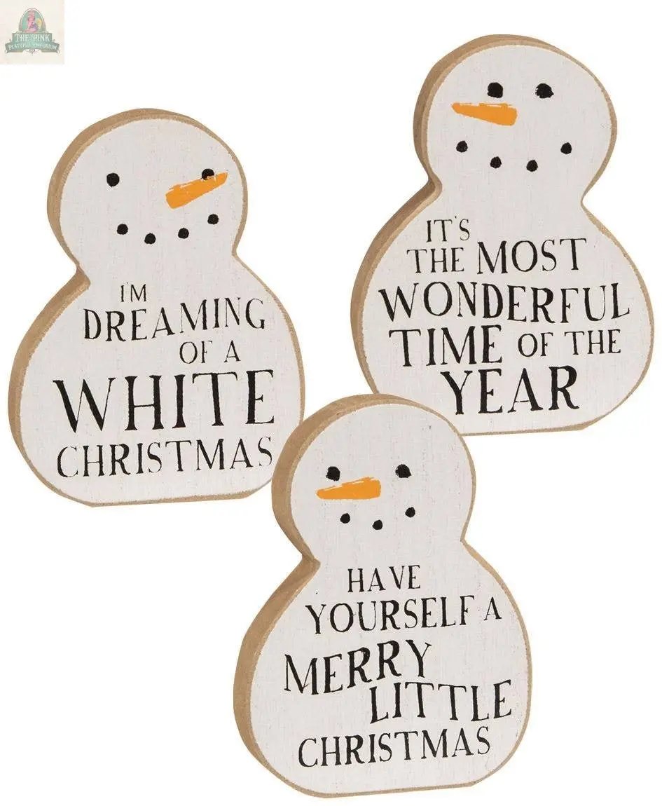 The Christmas Carol Chunky Snowman Sitter, 3 assorted, features wooden snowmen with carrot noses and festive sayings—ideal as farmhouse Christmas decor or charming wooden snowman decor for your holiday home.
