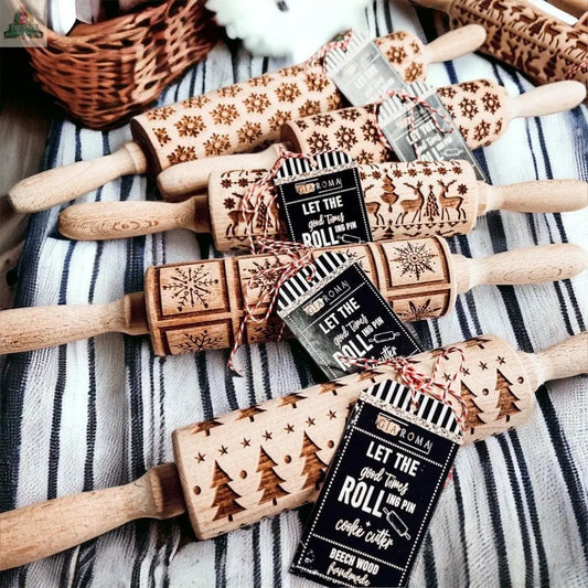 The Christmas Rolling Pin Set | 10 Styles features festive wooden pins with holiday patterns and twine-tied tags, perfect for gifting. Four pins rest on a striped cloth, with a wicker basket visible in the background.