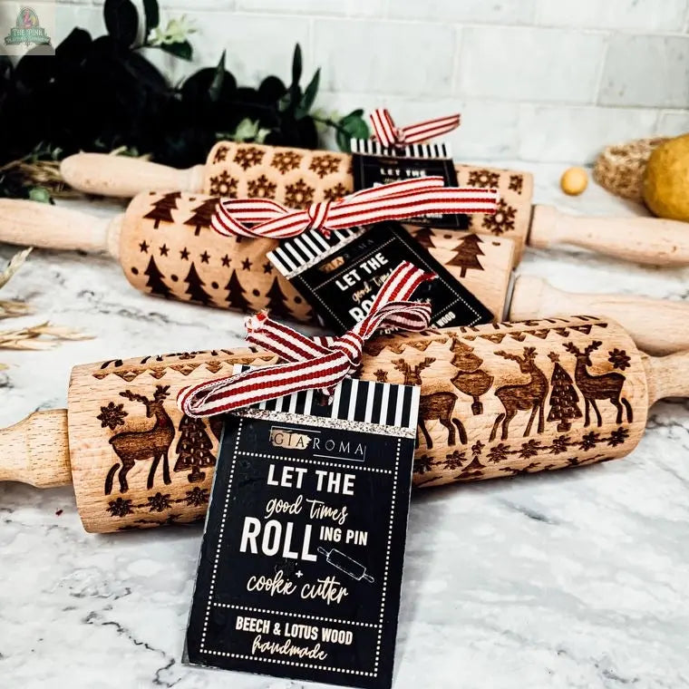 The Christmas Rolling Pin Set | 10 Styles features engraved pins with festive patterns, displayed on marble with striped ribbons and tags. Perfect for bakers or pairing with cookie cutters this holiday season!.