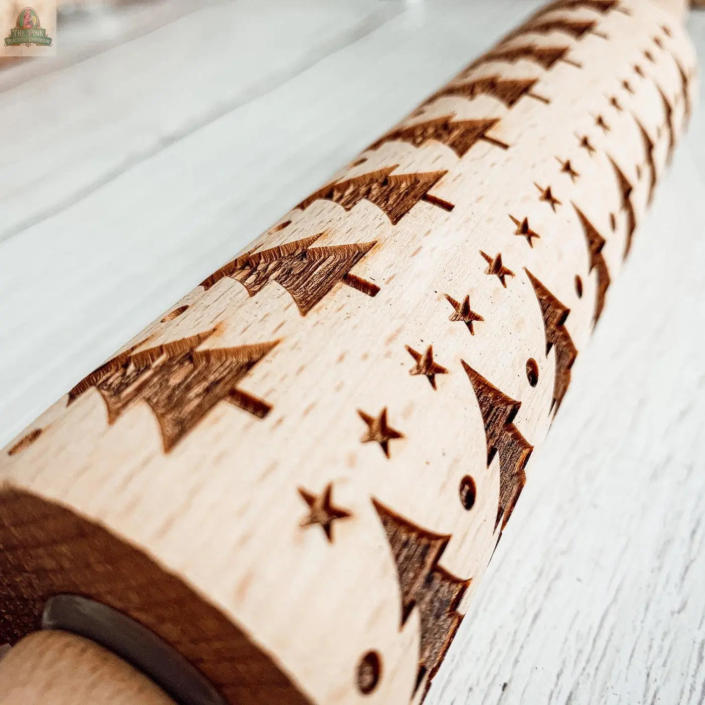 A close-up of the Christmas Rolling Pin Set | 10 Styles, featuring engraved Christmas trees and stars, perfect for holiday baking and displayed on a light wood surface.