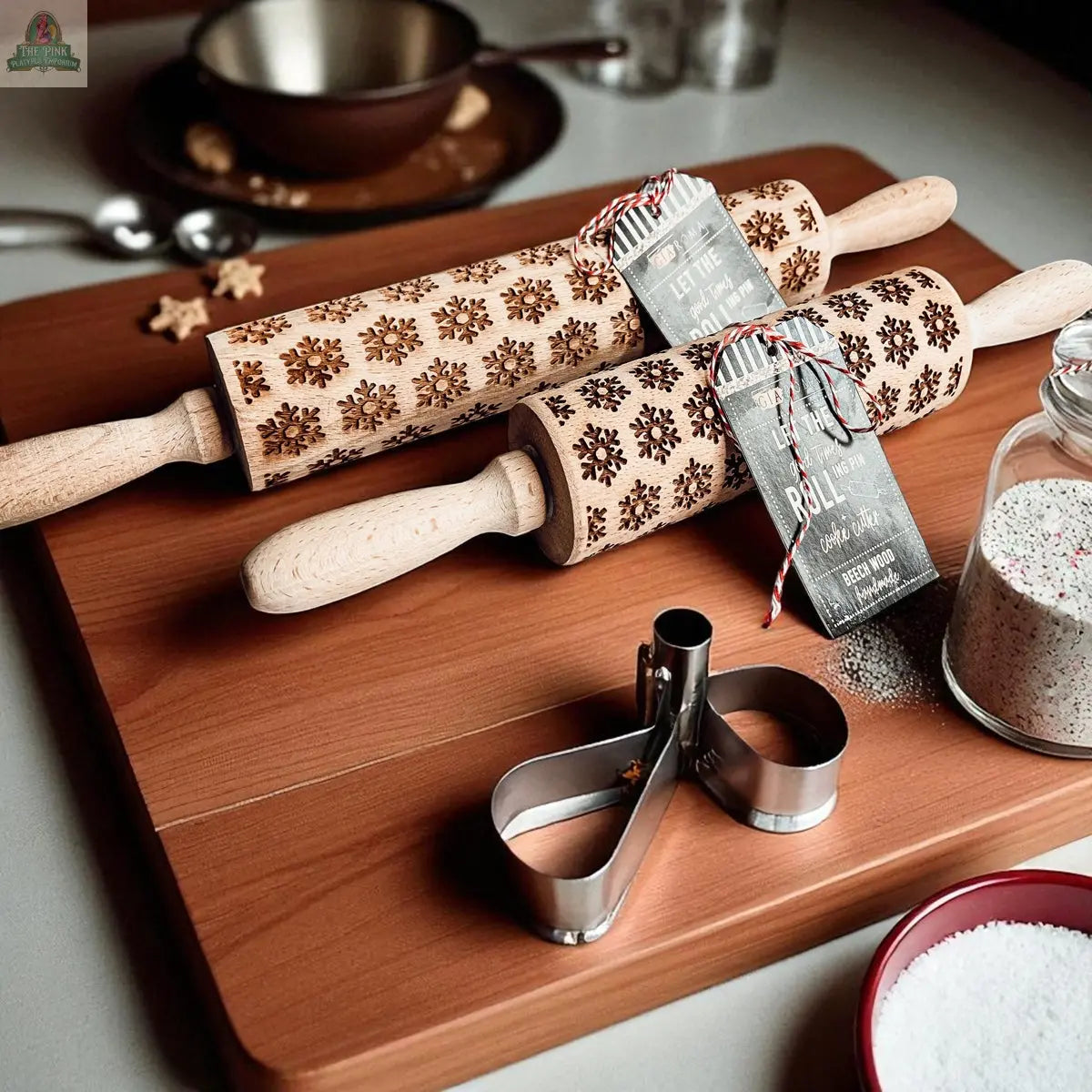 The Christmas Rolling Pin Set | 10 Styles is displayed on a wooden board with festive baking supplies, cookie cutters, and a jar of sugar, evoking the joyful spirit of holiday baking.