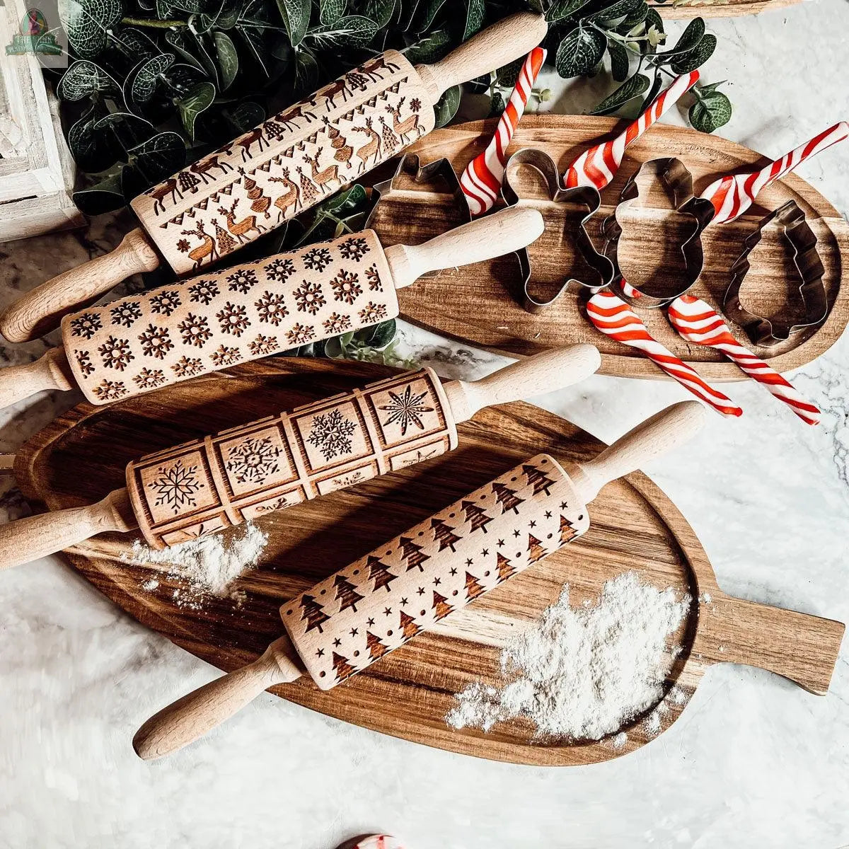 The Christmas Rolling Pin Set | 10 Styles features festive patterned pins, perfect for holiday bakers. Paired with candy cane stripes, metal cookie cutters, and flour-dusted boards, it creates a charming seasonal gift scene.
