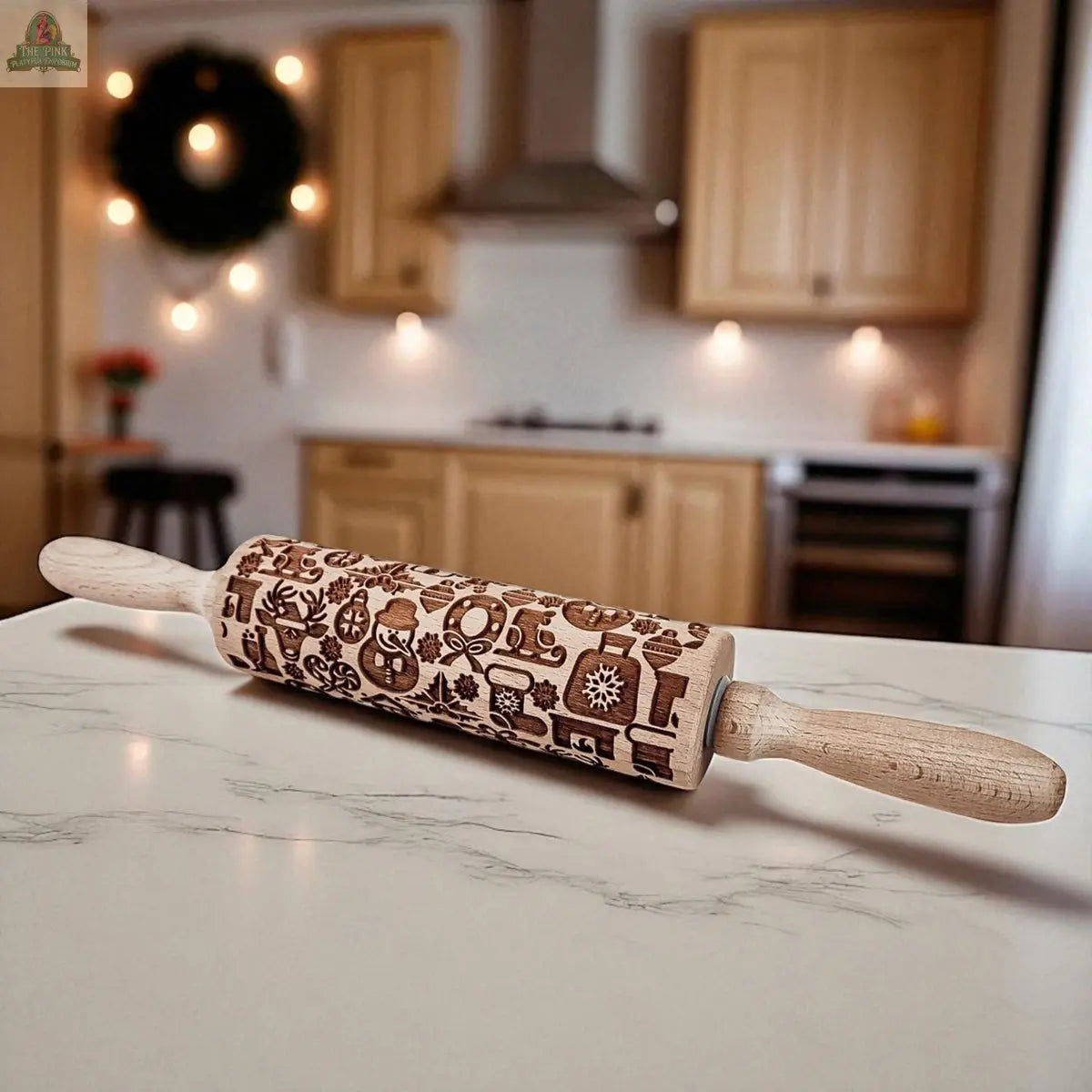 The Christmas Rolling Pin Set | 10 Styles sits on a marble counter, engraved with festive patterns—warm lighting and wooden cabinets in the background. An ideal baking gift to add holiday charm to any kitchen.