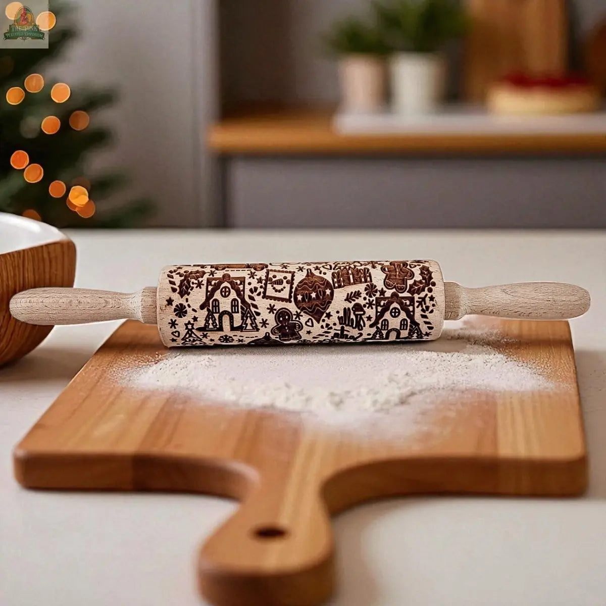 The Christmas Rolling Pin Set | 10 Styles, a perfect baking gift, sits on a floured cutting board in a cozy kitchen, with a blurred Christmas tree and festive accessories in the background.