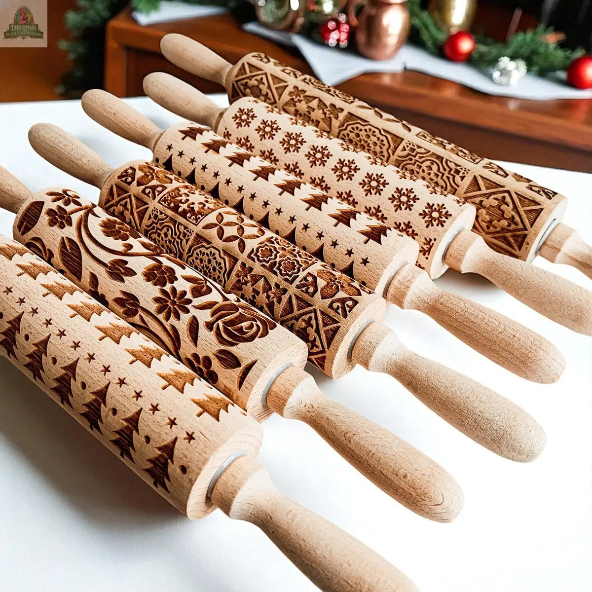 The Christmas Rolling Pin Set | 10 Styles features intricately patterned wooden rolling pins, ideal for festive baking gifts, showcased on a white surface with holiday decorations and cookie cutters.