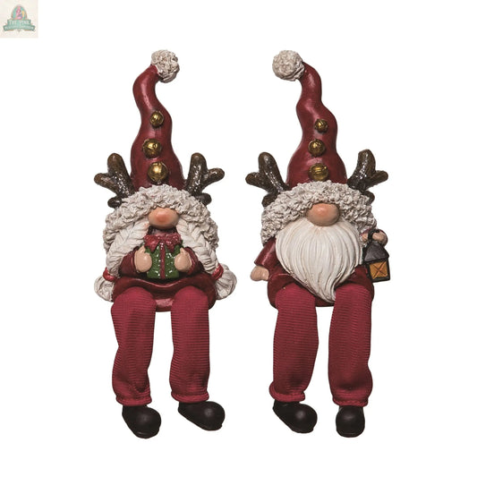 Resin Christmas Gnome Shelf Sitters with long red hats, reindeer antlers, festive outfits, dangling legs, and white pom-poms—one holds a present, the other a lantern. Charming holiday décor for shelves or mantels.
