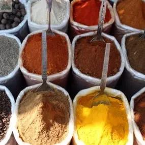 Country Spice Atomizer Oils, inspired by colorful sacks of ground spices like yellow turmeric and red chili powder arranged in market rows, capture the vibrant aromas of a potpourri refresher in every spray.