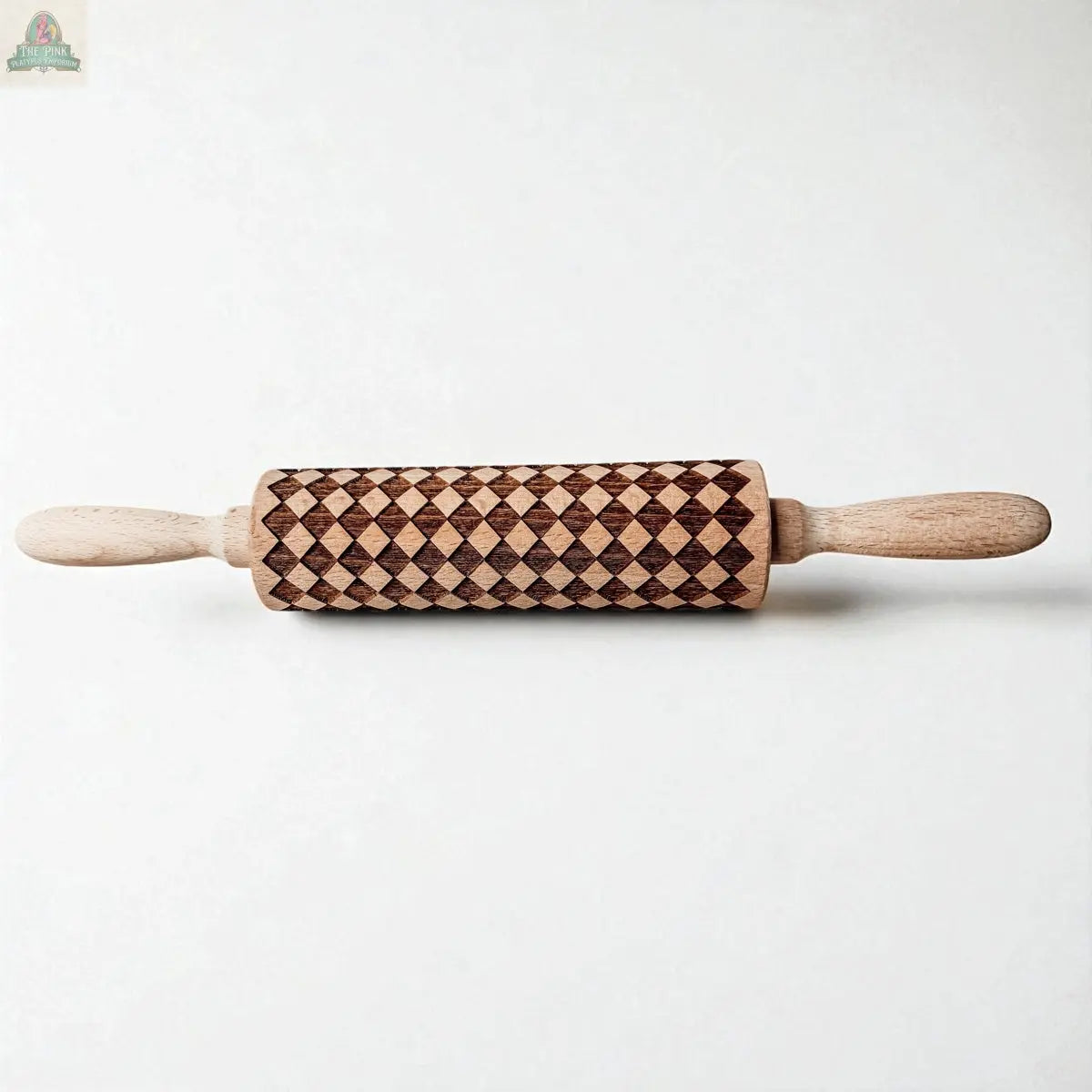 The Courtly Check Rolling Pin, featuring engraved diamond patterns on its wooden barrel, sits on a white background—a stylish upgrade for your baking collection.