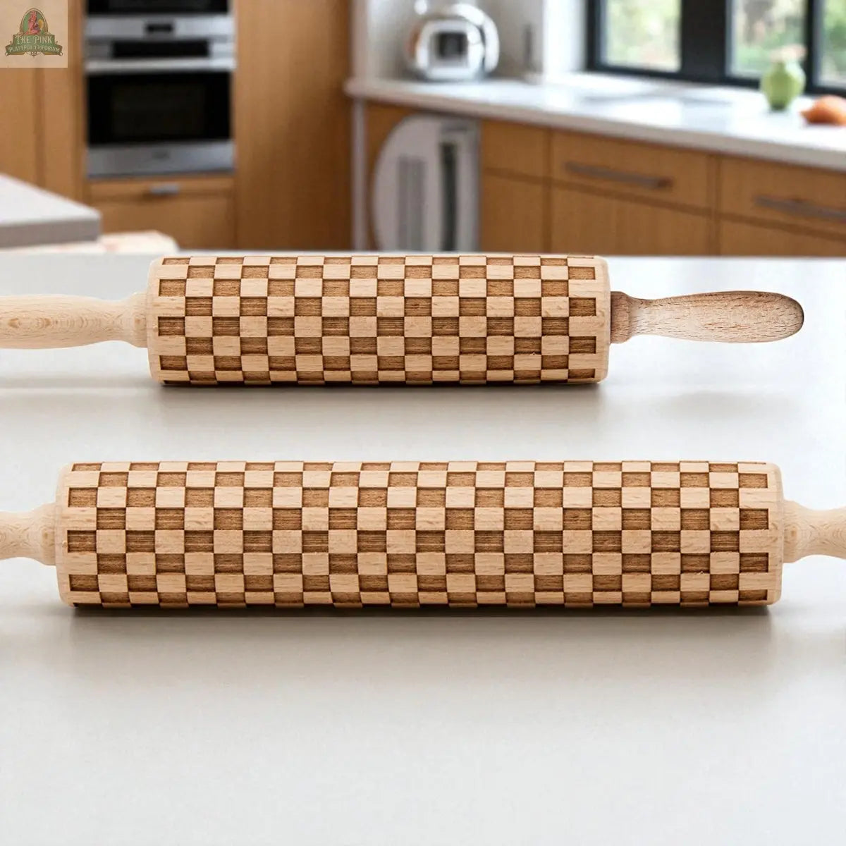 Two Courtly Check Rolling Pins rest on a white kitchen countertop, surrounded by sleek cabinets and appliances—perfect baking tools to pair with your favorite cookie cutters.