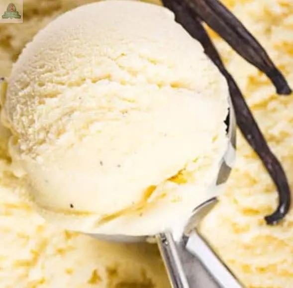 A close-up of Creamy Vanilla Bean Atomizer Oils being spritzed, with two vanilla beans in the background, highlighting the rich, sweet potpourri-like fragrance.