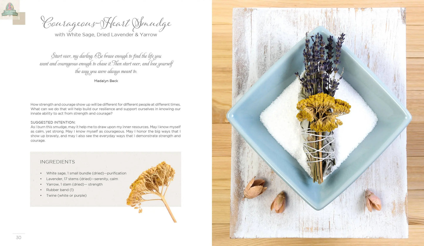 On a white wooden surface, REDFeather’s Creating Smudge Sticks Book is shown with bundles of dried white sage, lavender, and yarrow—ideal for making spiritual tools or smudging rituals. Dried nuts add a natural touch nearby.