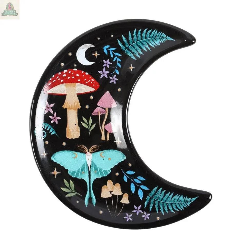 The Crescent Moon Dark Forest Print Trinket Dish features a turquoise moth, red and pink mushrooms, green ferns, purple flowers, and a tiny white moon—perfect as celestial decor or a unique jewelry holder.