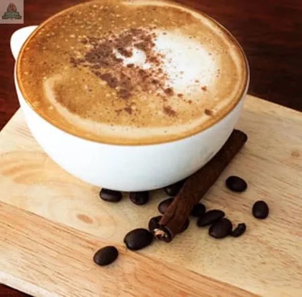 A bottle of Evening Mocha Atomizer Oils rests on a wooden board, surrounded by coffee beans, a cinnamon stick, and potpourri, creating a warm and cozy atmosphere with its inviting mocha fragrance.