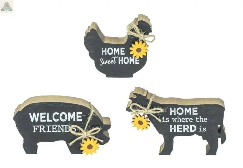 The Farm Critter w Sunflower Tabletop 3 Ast includes three wooden animal cutouts—a chicken, pig, and cow—each with a twine bow, sunflower accent, a white welcoming phrase, and measuring 3.74x0.98x3.35 inches.