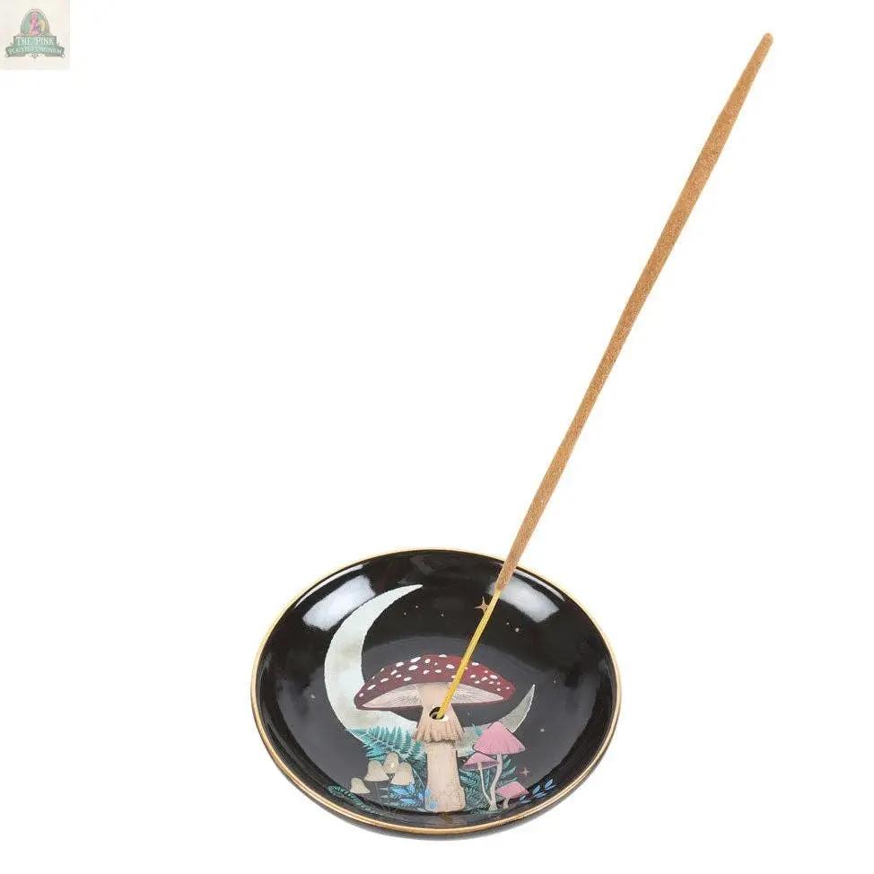 The Forest Mushroom Ceramic Incense Holder Plate is a round black ceramic plate featuring colorful mushrooms and a crescent moon, ideal for holding one incense stick—perfect as a mystical woodland gift or unique home decor accent.