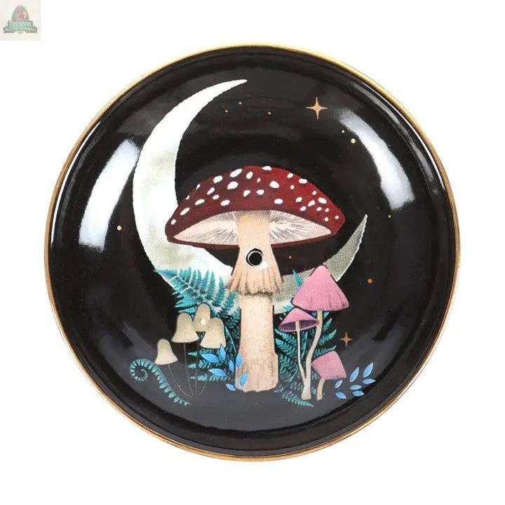 The Forest Mushroom Ceramic Incense Holder Plate is a round black plate with a gold rim, featuring painted mushrooms, ferns, a crescent moon, and golden stars—ideal for mystical woodland gifts or unique home decor.