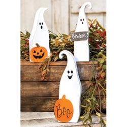 Halloween-themed decorations including ghosts and pumpkins on a wooden surface.