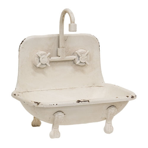 Vintage-style white metal sink soap holder with faucet on a white background