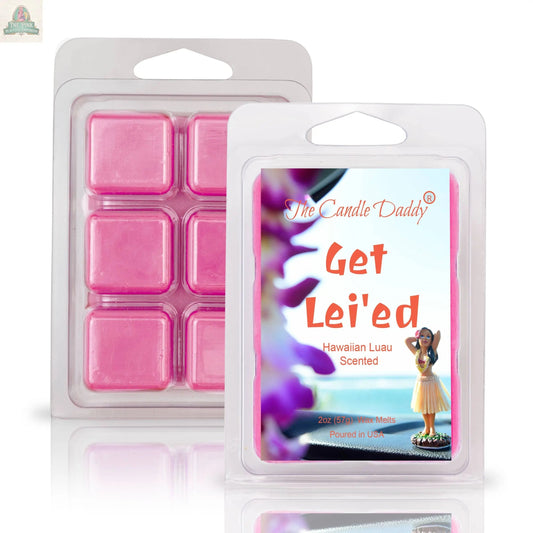 A pack of GET LEI'ED - HAWAIIAN LUAU SCENTED WAX MELT (2oz) is shown open with six pink cubes, alongside its packaging featuring a hula dancer, evoking a soothing aromatherapy experience.