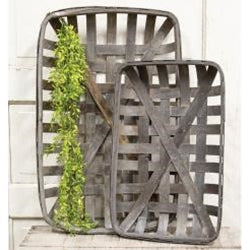 Two wooden baskets with a plant on a white background