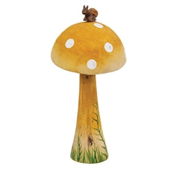 Decorative mushroom with a small snail figurine on top against a white background