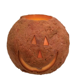 pumpkin-shaped LED candle with a jack-o'-lantern face on a white background