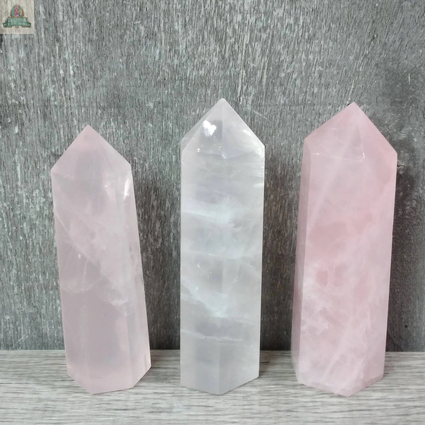 Three Keystone Crystals Coffee Bean Jasper gemstone obelisks (4–5 oz bulk crystal towers) stand upright on a light wooden surface, set against a textured gray background.
