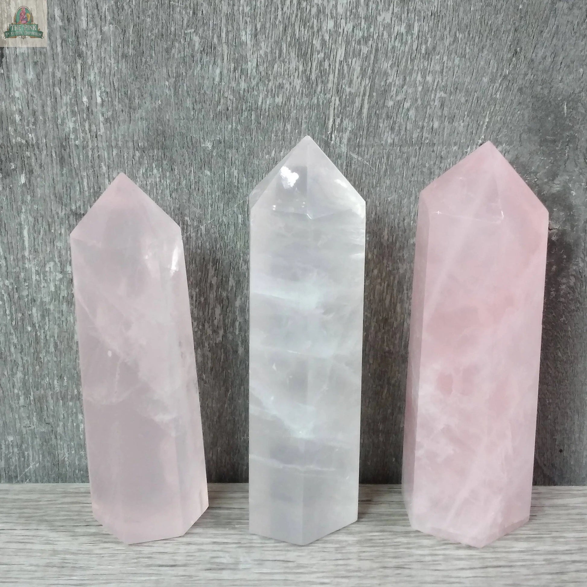Three Keystone Crystals Coffee Bean Jasper gemstone obelisks (4–5 oz bulk crystal towers) stand upright on a light wooden surface, set against a textured gray background.