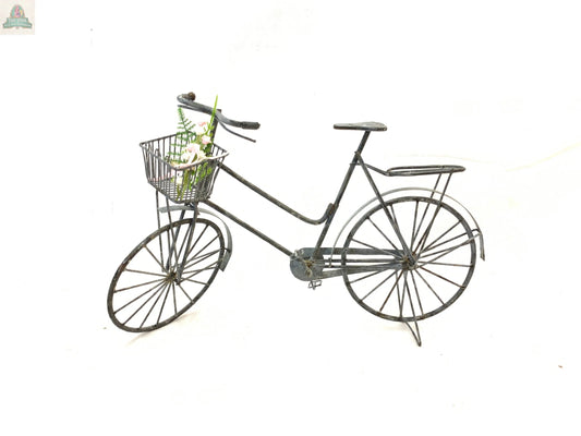 The HANDMADE LARGE GRAY ZINC WIRE BICYCLE WITH BASKET features vintage metal craftsmanship, filled with artificial white flowers and greenery—ideal for rustic home decor—and is shown against a plain white background.