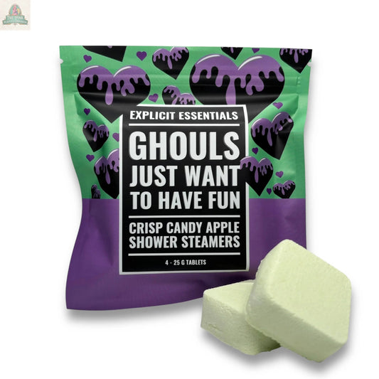Explicit Essentials’ Halloween Shower Steamers | Spooky Season Gift comes in a colorful “Ghouls Just Want To Have Fun” package, featuring black hearts with purple drips on a green and purple background, plus two light green shower steamer tablets.