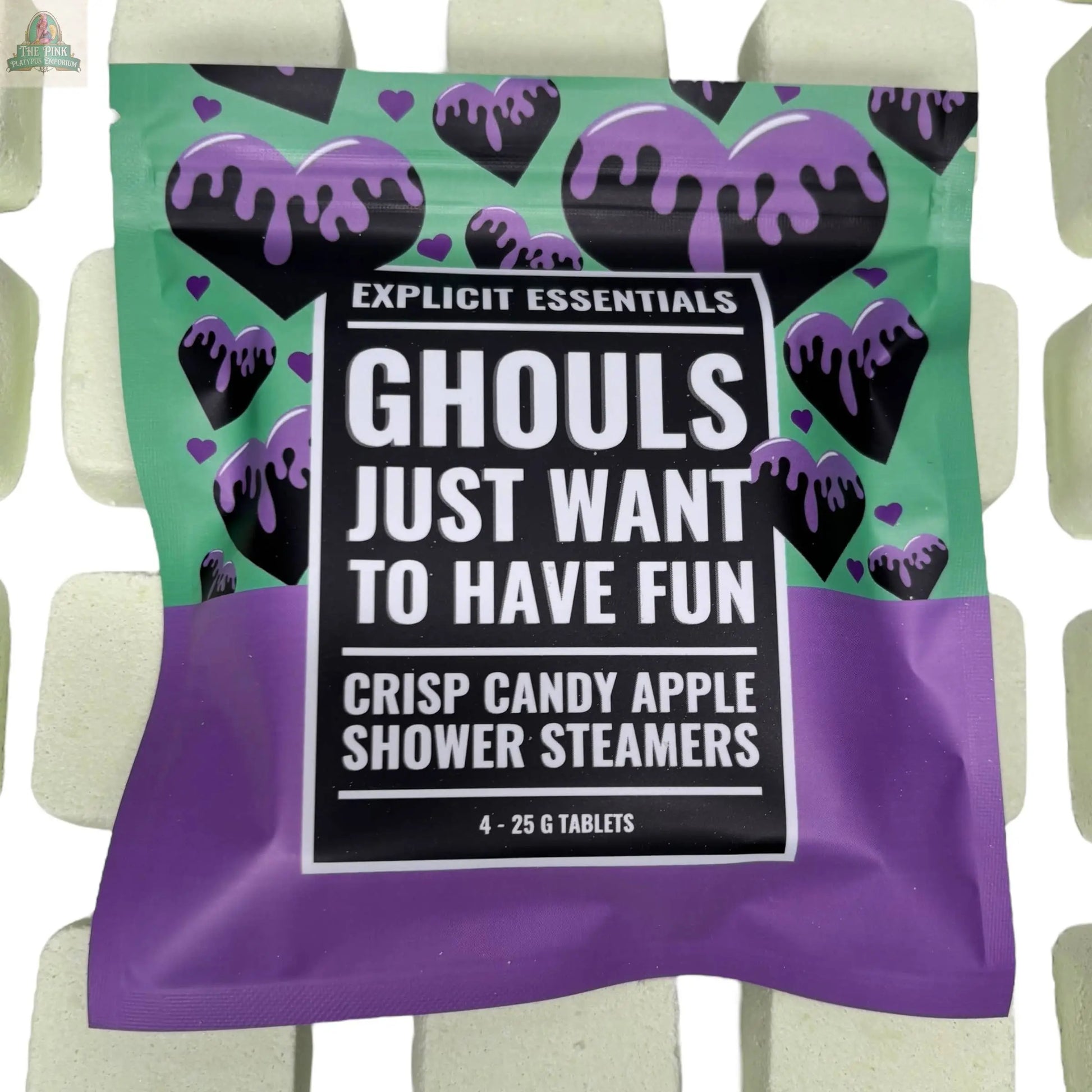 Explicit Essentials Halloween Shower Steamers | Spooky Season Gift come in green and purple packaging with dripping black hearts, surrounded by white tablets—a perfect Halloween self-care treat.