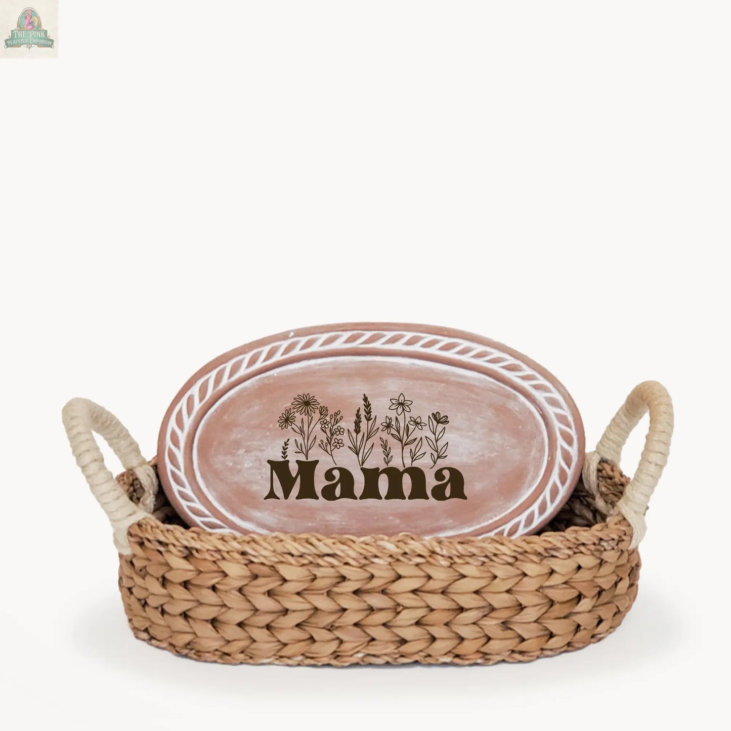 The Handmade Bread Warmer & Wicker Basket - Mom Oval: Design 3 includes a handled wicker basket and a pink oval plate with a floral "Mama" design and white border, making it a charming and thoughtful gift for bread lovers.