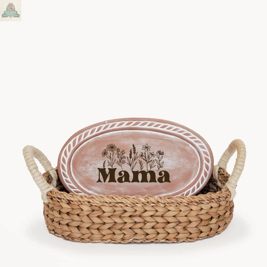 The Handmade Bread Warmer & Wicker Basket - Mom Oval: Design 3 includes a handled wicker basket and a pink oval plate with a floral "Mama" design and white border, making it a charming and thoughtful gift for bread lovers.
